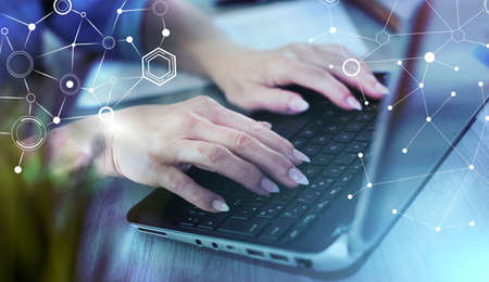 Female hands typing on laptop; light effect