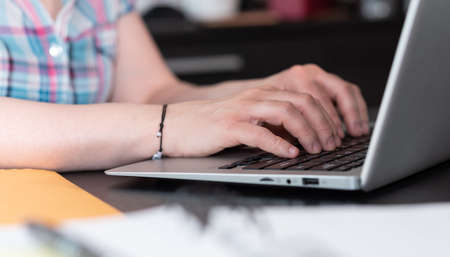 Female hands working on laptop in office