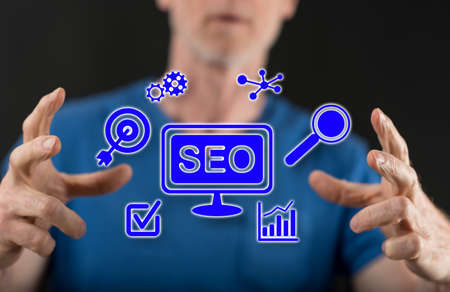 SEO concept between hands of a man in backgroundの写真素材