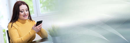 Young businesswoman using her mobile phone; panoramic banner