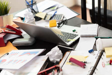 Messy and cluttered office deskの写真素材