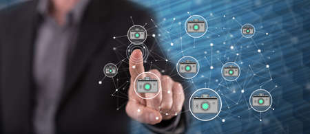 Man touching a photo sharing concept on a touch screen with his finger
