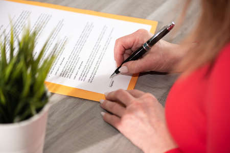 Businesswoman signing a contractの写真素材