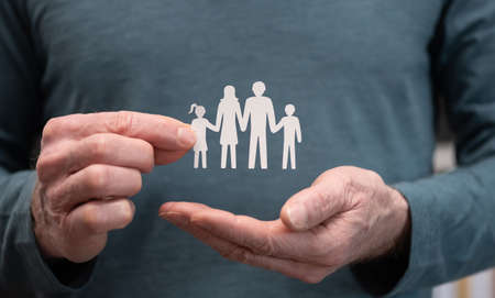 Concept of family insurance with family held by insurerの写真素材