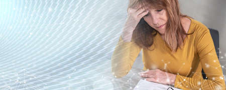 Exhausted businesswoman sitting in office with hand on forehead; panoramic banner