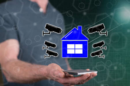 Security camera concept above a smartphone held by a man in backgroundの写真素材