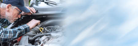 Car mechanic checking a car engine; panoramic bannerの写真素材