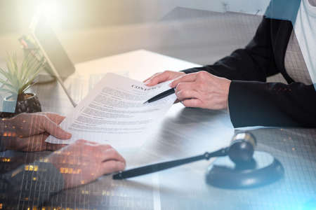 Female lawyer showing a document to her client. legal, advice and justice concept; multiple exposureの写真素材