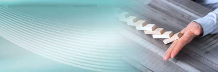 Business control concept by stopping domino effect; panoramic banner