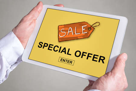 Tablet screen displaying a special offer conceptの写真素材