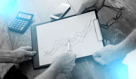 Team discussing about financial charts; light effect