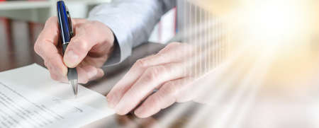 Businessman signing a document, closeup; multiple exposure
