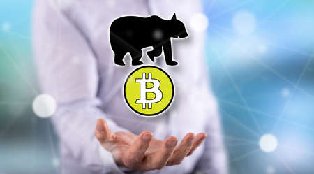 Bitcoin bearish trend concept above the hand of a man in background