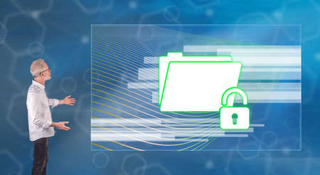 Businessman showing a data protection concept on a wall screen