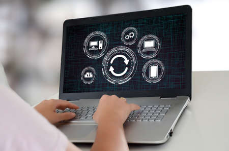 Woman using a laptop with system update concept on the screen