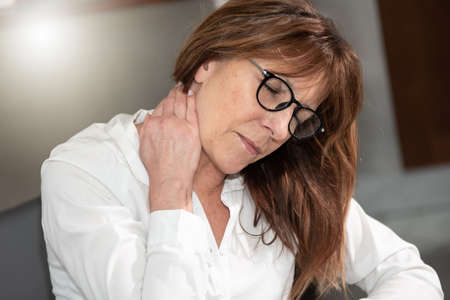 Middle age businesswoman suffering from neck pain