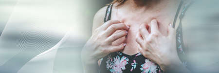Woman having itchy and scratching her chest; panoramic bannerの写真素材