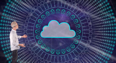 Businessman showing a cloud networking concept on a wall screen