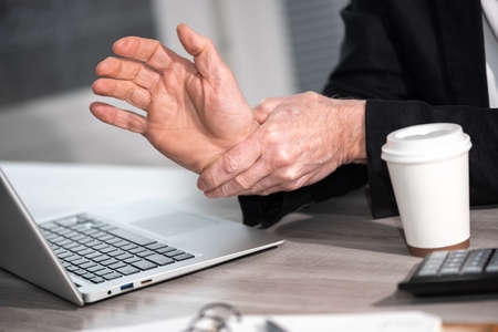 Businessman suffering from wrist pain