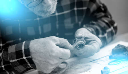 Plumber preparing fitting sealing with hemp fibers; light effect