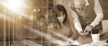 Coworkers working on financial data in office; multiple exposure