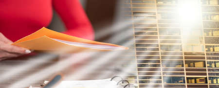 Businesswoman holding folder with paper documents; multiple exposureの写真素材