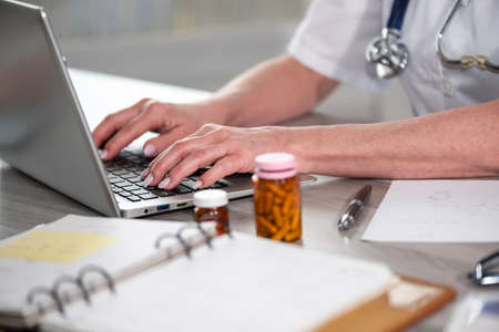 Female doctor using laptop in medical officeの写真素材