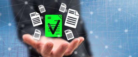Document validation concept above the hand of a man in backgroundの写真素材