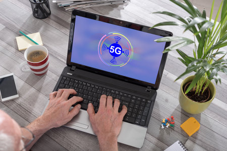 Man using a laptop with 5g concept on the screenの写真素材