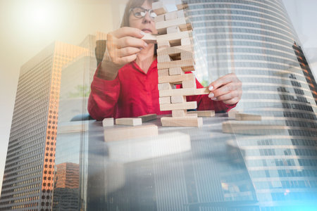 Concept of business risk with domino blocks; multiple exposureの写真素材