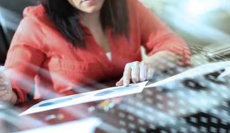 Young businesswoman working on documents at office, light effectの写真素材