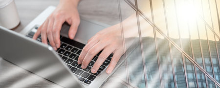 Female hands typing on laptop keyboard; multiple exposure