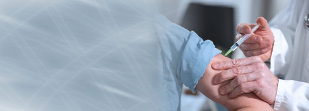 Doctor injecting vaccine to female patient; panoramic banner