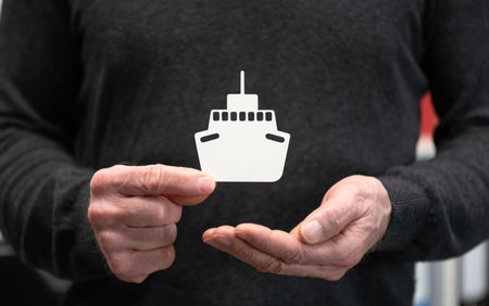 Man holding a paper boat; Concept of boat insuranceの写真素材