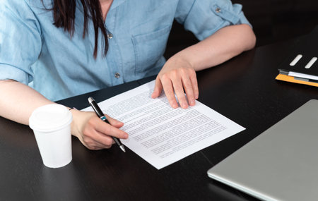 Businesswoman checking document in officeの写真素材