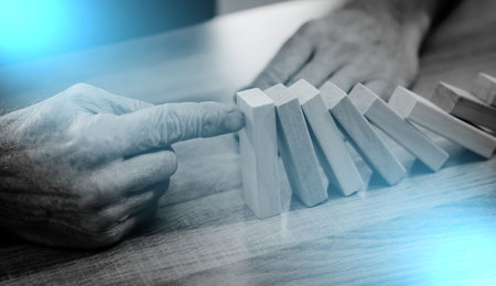 Business control concept by stopping domino effect; light effectの写真素材