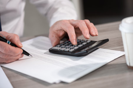 Male hands using calculator. Concept of finance and economy