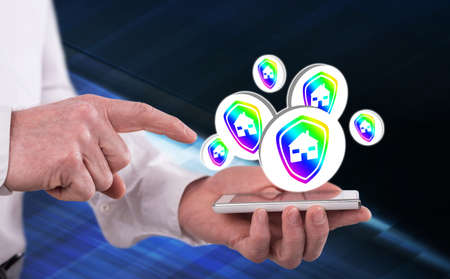 House protection concept above a smartphone held by a man