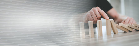 Business control concept by stopping domino effect; panoramic bannerの写真素材