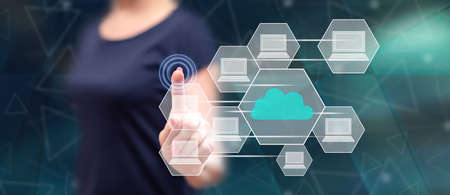 Woman touching a cloud computing concept on a touch screen with her finger