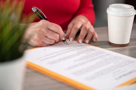 Businesswoman signing a contractの写真素材