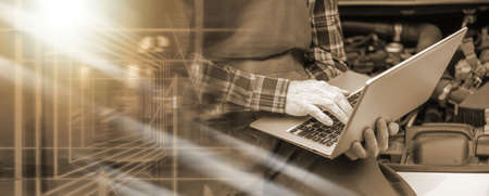 Car mechanic using laptop for checking car engine; multiple exposure
