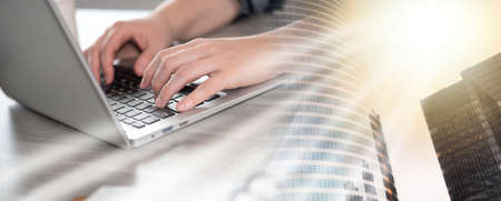 Female hands typing on laptop keyboard; multiple exposure
