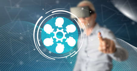 Man with vr headset touching a social network concept on a touch screen with his finger