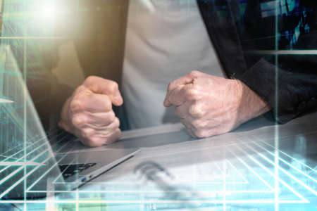 Angry businessman hitting his desk with his clenched fists; multiple exposure