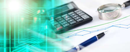 Magnifying glass, calculator, pen on a financial graph; multiple exposure