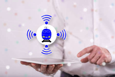 Smart train concept above a tablet held by a man in background