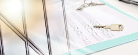 House keys on an amortization schedule, closeup; multiple exposure