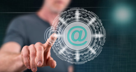 Man touching an email concept on a touch screen with his fingerの写真素材