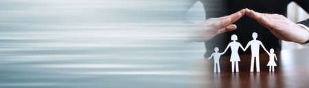 Insurer protecting a family, concept of insured family; panoramic banner